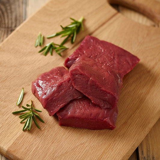 Raw loin medallions on a wooden cutting board with rosemary sprigs.